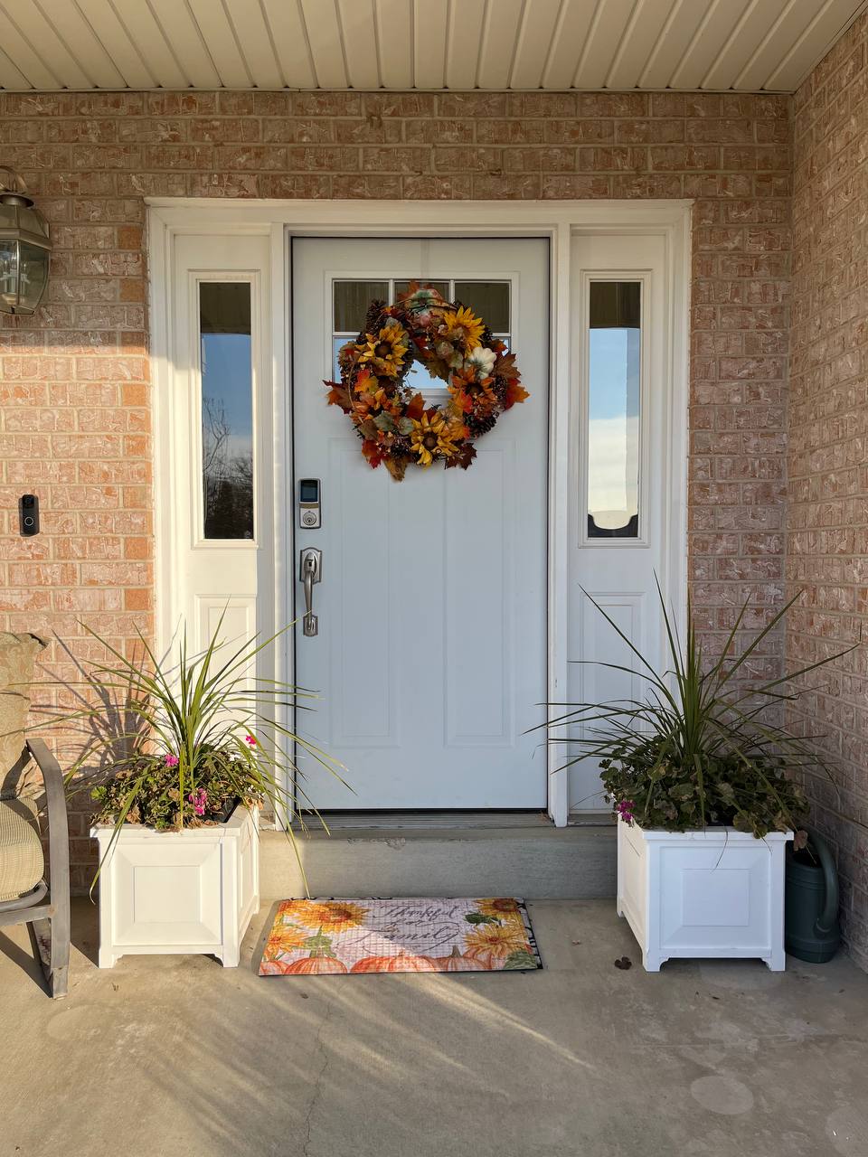 Front door on the exterior of the house. Currently a very light blue with white trim.