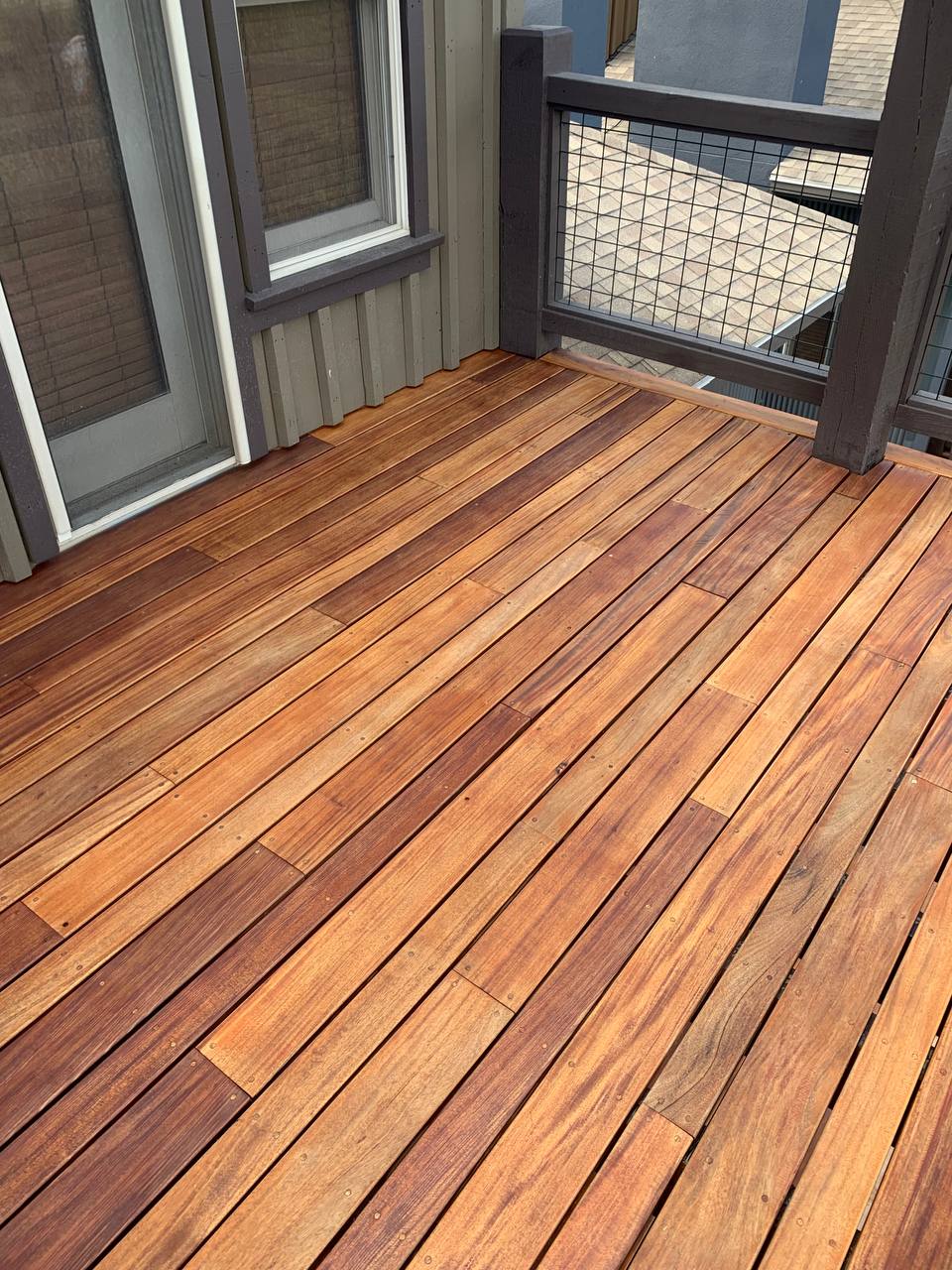 Deck after being stained. Bright orange and brown tones.