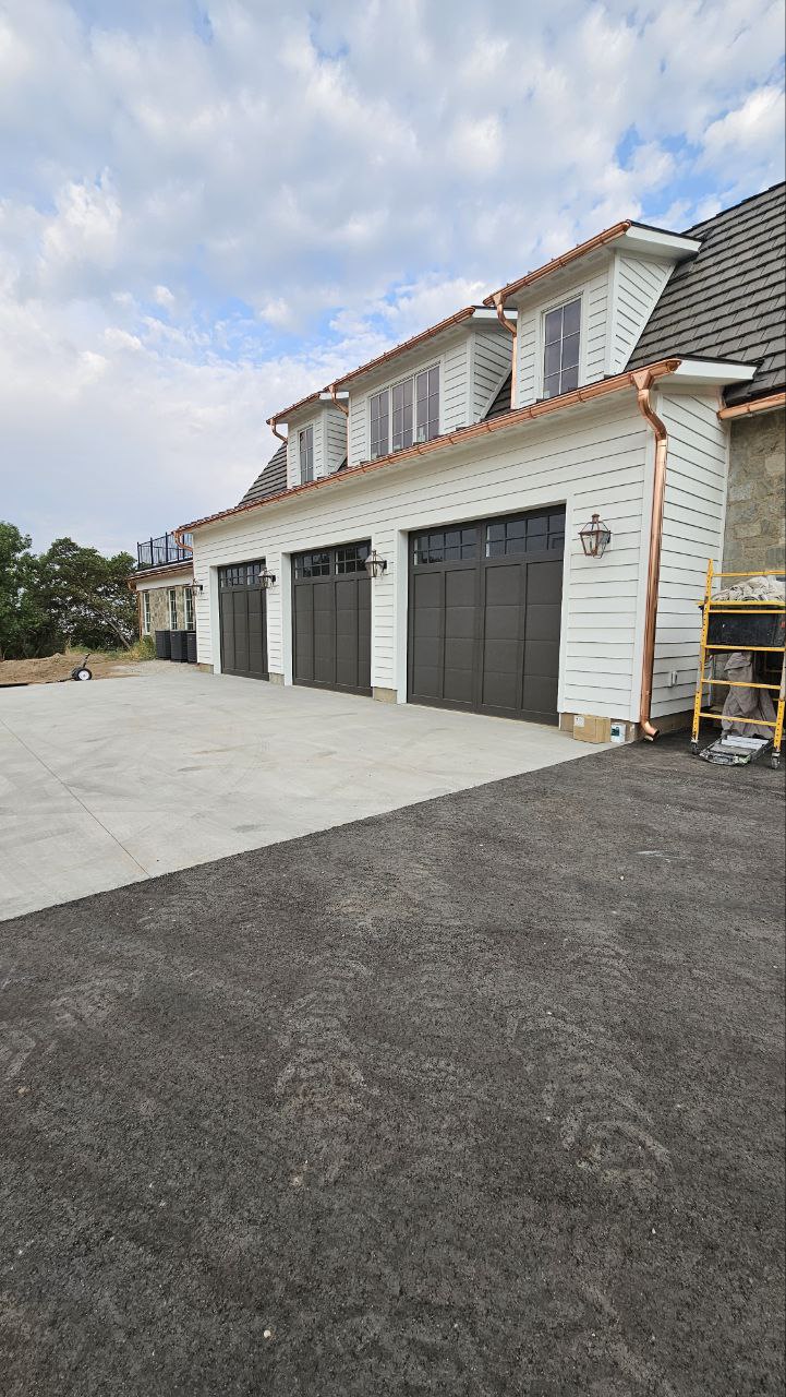 Newly painted exterior siding and garage doors.